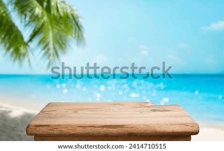 Aged wooden pedestal with free space and blurred summer beach landscape as background