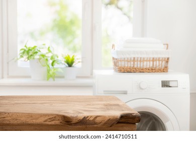 Aged wooden table for product display on blur washing machine in laundry room background - Powered by Shutterstock