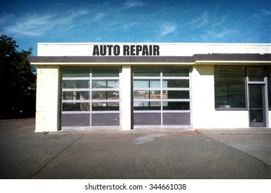 Aged And Worn Vintage Photo Of Abandoned Auto Repair Garage                