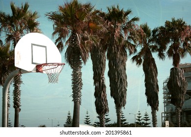  Aged And Worn Vintage Photo Of Basketball Hoop At Beach With Palm Trees                             