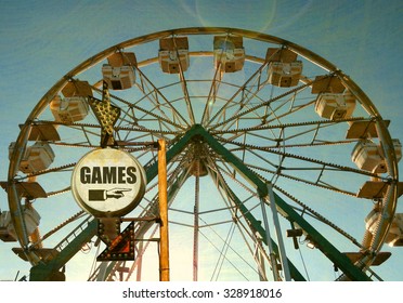 Aged And Worn Vintage Photo Of Carnival Games Sign With Ferris Wheel             