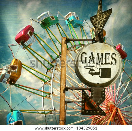 aged and worn vintage photo of carnival games sign with ferris wheel                              