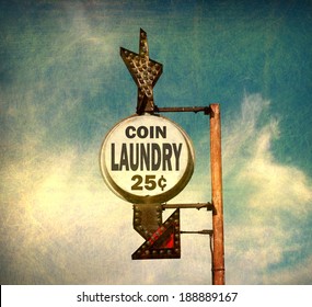 aged and worn vintage photo of coin laundry sign