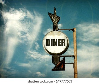aged and worn vintage photo of diner sign with arrow                               