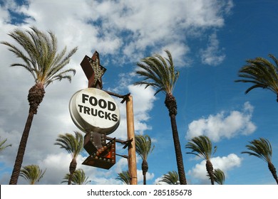 aged and worn vintage photo of food trucks sign with palm trees                             - Powered by Shutterstock