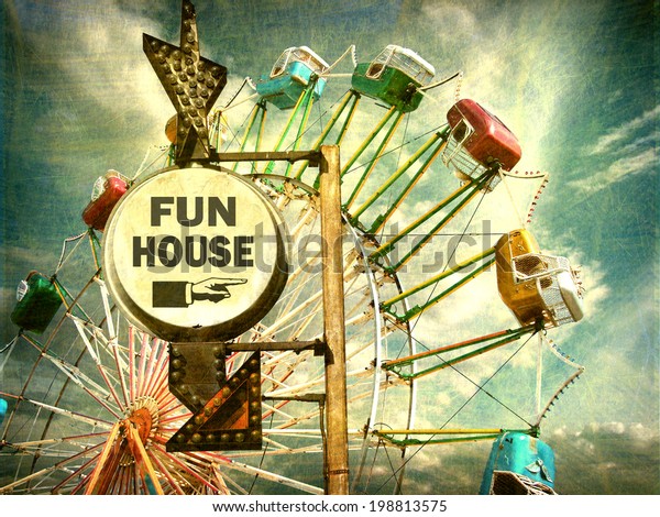 aged and worn vintage photo of fun\
house sign with ferris wheel                              \
