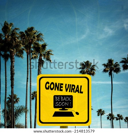 aged and worn vintage photo of gone viral sign on beach with palm trees