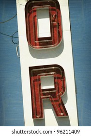 Aged And Worn Vintage Photo Of  Letters On Neon Sign