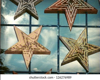  Aged And Worn Vintage Photo Of Neon Sign Stars
