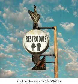 Aged And Worn Vintage Photo Of Restroom Sign With Arrow