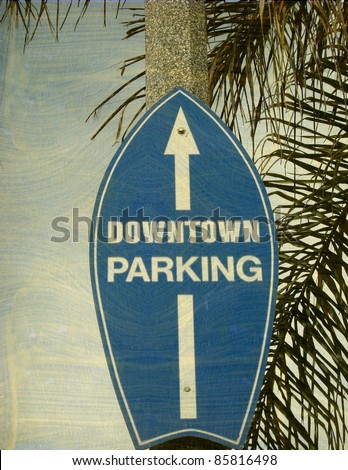 aged and worn vintage photo of surfboard downtown beach city street sign