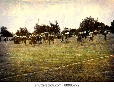 aged and worn vintage photo of unidentifiable young american football players on field