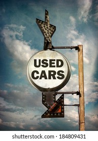  aged and worn vintage photo of used cars sign with arrow                              