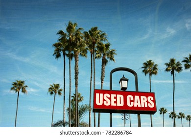 Aged And Worn Vintage Photo Of Used Cars Sign With Palm Trees