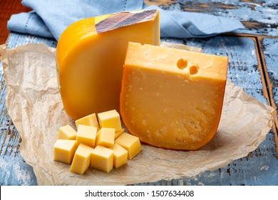 Aged And Young Dutch Gouda Cheese And Cheese Cubes Blocks, Tasty European Food Close Up