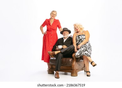 Ageless Generation. Elegant Senior Man And Two Charming Women In Vintage Retro Style Outfits Isolated On White Background. Concept Of Relations, Family, 1960s American Fashion Style And Art.