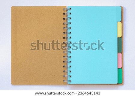 Agenda and organizer concept, Opened blank bookmark or post it in multi colored layer, Empty notebook with lines for your diary or short note, Free copy space for your text on white background.