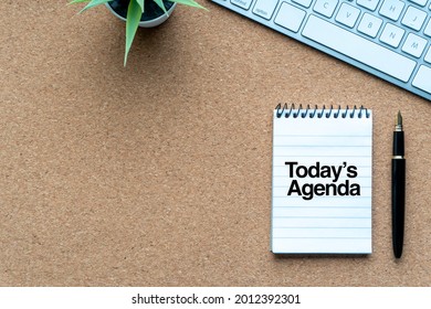 TODAY’S AGENDA text with notepad, decorative plant, keyboard and fountain pen on wooden background. Business and copy space concept - Shutterstock ID 2012392301