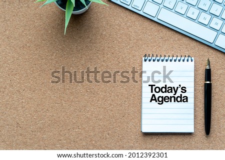 TODAY’S AGENDA text with notepad, decorative plant, keyboard and fountain pen on wooden background. Business and copy space concept