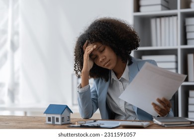 agent, american businesswoman Africans are working hard, stressed, and having a headache with the leasing contract paperwork. Financial agreements, loans, mortgages, rentals, insurance, real estate - Shutterstock ID 2311591057