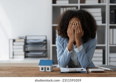 agent, american businesswoman Africans are working hard, stressed, and having a headache with the leasing contract paperwork. Financial agreements, loans, mortgages, rentals, insurance, real estate - Shutterstock ID 2311591059