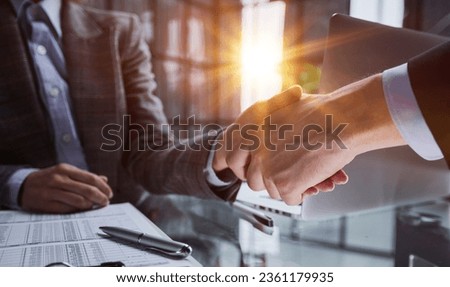 Agent and client shaking hands after signed document and done business deal for transfer right of property.