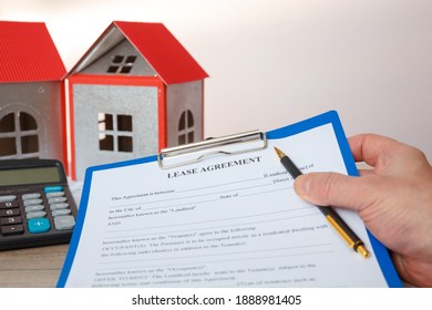 The agent holds the form of the real estate lease, house models, calculator.