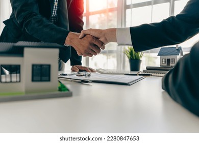 agent, lease, successful management
					Real estate brokerage manager shaking hands with client after signing home purchase contract in real estate agency office