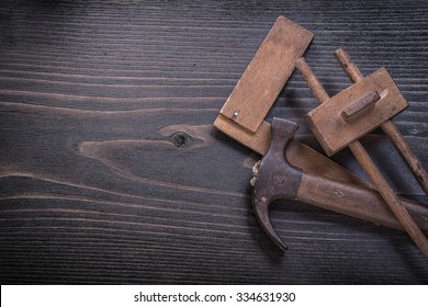 Age-old Claw Hammer Square Ruler Carpenter Gauge On Wood Board.