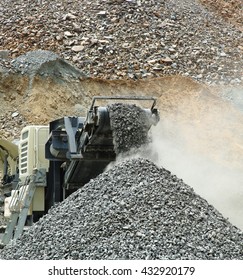 Aggregate Production By Mobile Crusher.  Conveyor Belt Of A Working Mobile Crusher Machine, Close-up, With Blown Away By The Wind White Stone Dust.