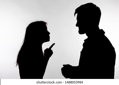 Aggression And Abuse Concept - Man And Woman Expressing Domestic Violence In Studio Silhouette Isolated On White Background.