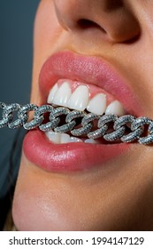 Aggression Woman With Chain In Teeth Close Up . People And Aggression Concept Close Up. Emotional Angrily Screams