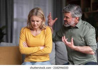 Aggressive Behavior. Portrait Of Abusive Husband Shouting At Wife At Home, Angry Middle Aged Man Screaming At Spouse With Rage, Scared Depressed Woman Suffering Domestic Violence, Closeup - Shutterstock ID 2182946333