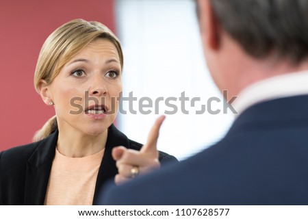 Aggressive Businesswoman Shouting At Male Colleague