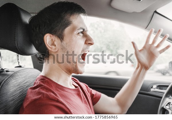 aggressive driver shouts and swears at another\
driver on a city street during rush hour. The concept of mutual\
respect and resolution of personal\
conflicts