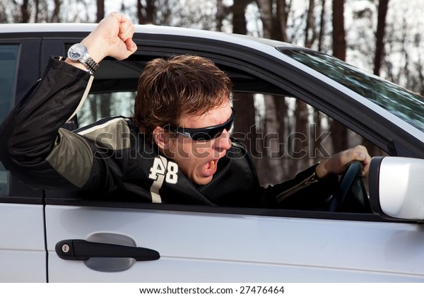 Aggressive driver, young man driving left\
side driving car\
aggressively