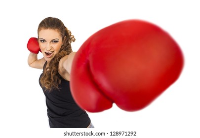 The aggressive girl in boxing gloves strikes blow
