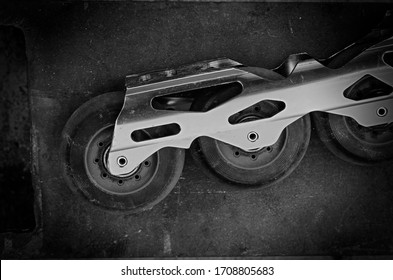 Aggressive Inline Skates Disassembled. Professional Roller Blades On The Floor. Hard Alloy Roller Blade. Repair Of Sports Equipment. Overhead View