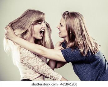 Aggressive Mad Women Fighting Each Other Pulling Hair. Two Young Girls Struggling Win Catfight. Violence.