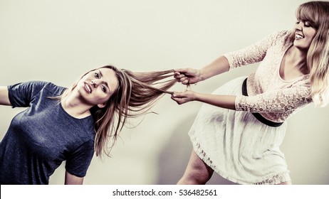 Aggressive Mad Women Fighting Each Other Pulling Hair. Two Young Girls Struggling Win Catfight. Violence.