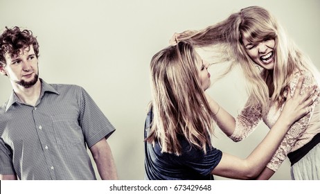 Aggressive Mad Women Fighting Over Man Pulling Hair. Jealous Girls Wooing Guy. Violence.