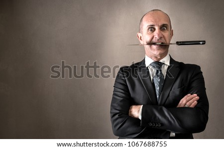 Aggressive manager with knife between teeth