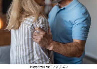 Aggressive nervous angry adult caucasian husband holds and threatens to wife in living room interior, cropped. Relationship problems, quarrel, beating, domestic violence, abuse and tyranny at home - Shutterstock ID 2191048687