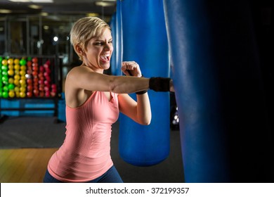 Aggressive Scream Yell Punch Kick Training Serious Strike On Bag In Gym Workout