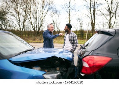 Aggressive senior male driver arguing over blame for car accident with a younger male motorist - Shutterstock ID 1964163820