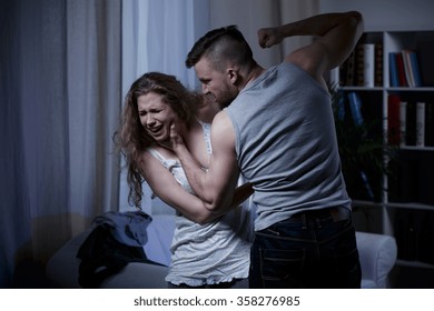 Aggressive Strong Man Hitting His Woman With Fist