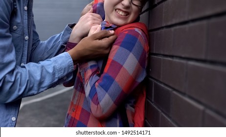 Aggressive Teenager Pushing Nerd Boy To Wall, Threatening Physical Harm Bullying