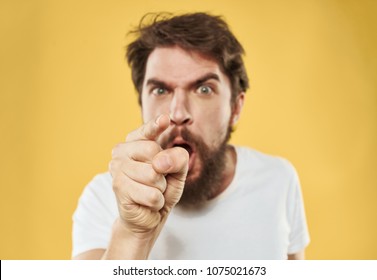 Aggressive, Unbalanced Man On A Yellow Background                              