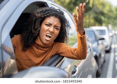 Aggressive woman driving car shouting at someone - Shutterstock ID 1815493340