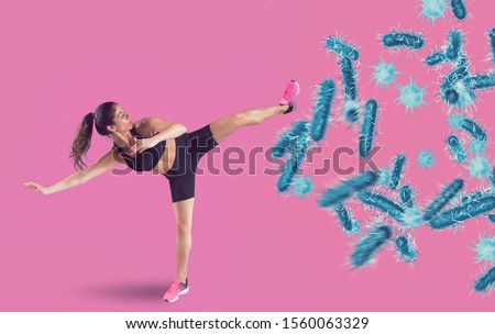 Aggressive woman fights with a kick against bacteria and disease